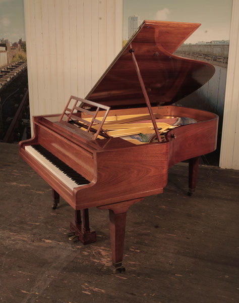 A 1927, Bluthner grand piano with a polished, rosewood case and square, tapered legs. Piano has an eighty-eight note keyboard and a two-pedal lyre