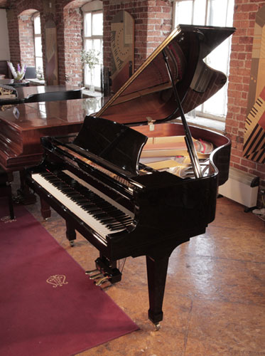 Reconditioned,  2000, Boston GP156 II baby grand piano with a black case and spade legs. Designed by Steinway. Piano has an eighty-eight note keyboard and a three-pedal lyre. 