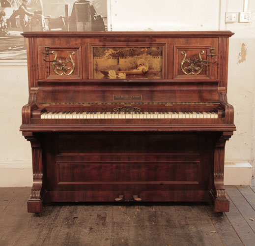 A 1905, Brinsmead upright piano with a polished, rosewood case and front panel featuring a crystoleum of a Pre Raphaelite scene
