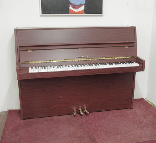 A 1977, Fazer upright piano with a mahogany case and Langer 80 action. Piano has an eighty-eight note keyboard and and three pedals 