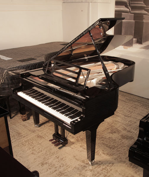 Brand new, Feurich model F218 Concert I grand piano with a black case and square tapered legs. Piano features  gunmetal frame. Piano has an eighty-eight note keyboard and a three-pedal piano lyre.  