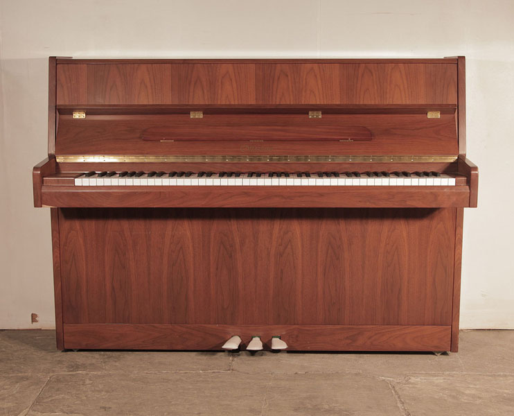 Ottostein SU-108P upright piano with a crown-cut walnut case.   Piano has an eighty-eight note keyboard and three pedals. 