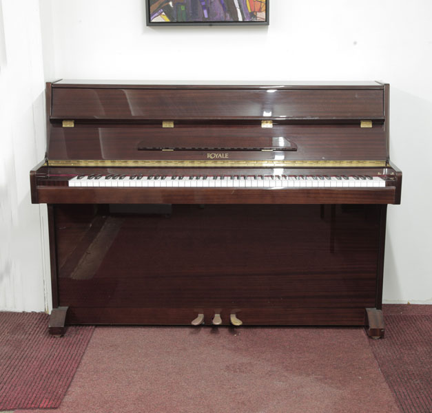 Royale VS-41 upright piano with a mahogany case. Piano has an eighty-eight note keyboard and three pedals.