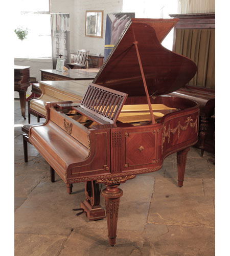 A 1901, Schiedmayer grand piano for sale with a quarter cut mahogany case. Entire cabinet features ormolu mounts of beading, swags, bows and festoons. Piano has an eighty-five note keyboard and a two-pedal lyre 