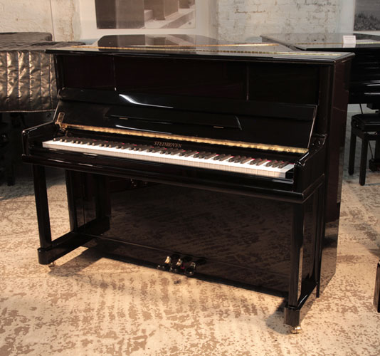Reconditioned, Steinhoven upright piano for sale with a black gloss case. Piano has an eighty-eight note keyboard and three pedals
