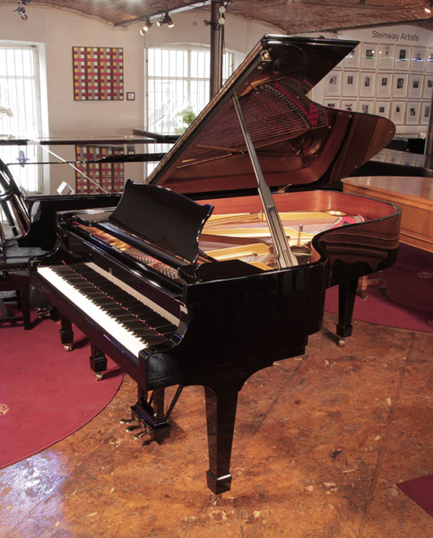 Reconditioned, 2006,  Steinway Model B grand piano for sale with a black gloss case and spade legs. Piano has a three-pedal lyre and an eighty-eight note keyboard. 