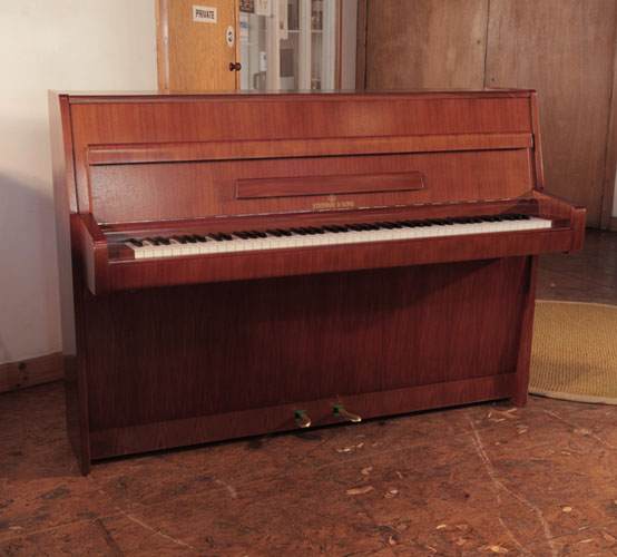 Reconditioned, 1968, Steinway Model F upright piano for sale with a walnut case and brass fittings. Piano has an eighty-eight note keyboard and two pedals.    