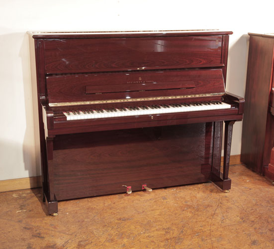 As new, 2009, Steinway Model V  upright piano for sale with a mahogany gloss case. Piano has an eighty-eight note keyboard and two pedals. 
