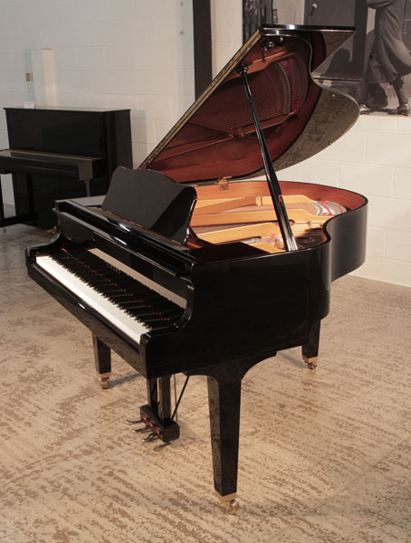 Reconditioned, 2005,   Yamaha GB1 baby grand piano for sale with a black, gloss case and square, tapered legs. Piano has an eighty-eight note keyboard and a three-pedal lyre. 