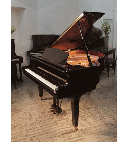 As new, 2022, Yamaha GB1 baby grand piano for sale with a black, gloss case and square, tapered legs. Piano has an eighty-eight note keyboard and a three-pedal lyre. 