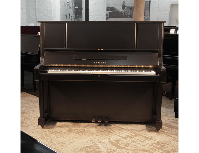 Reconditioned, 1981, Yamaha YUX upright piano for sale with a satin, black case and brass fittings. Piano has an eighty-eight note keyboard and three pedals. 